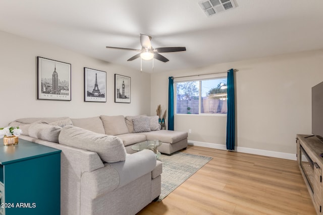 living room featuring ceiling fan and light hardwood / wood-style flooring