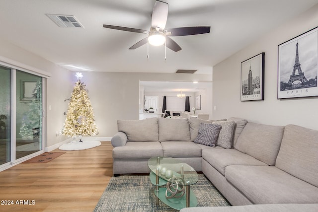 living room with ceiling fan and hardwood / wood-style floors