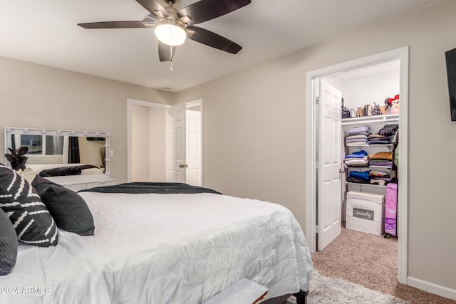 carpeted bedroom with ceiling fan and a closet