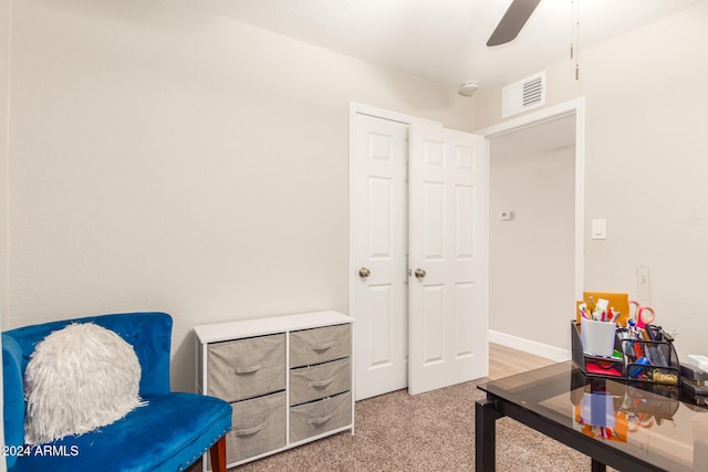 sitting room featuring carpet and ceiling fan