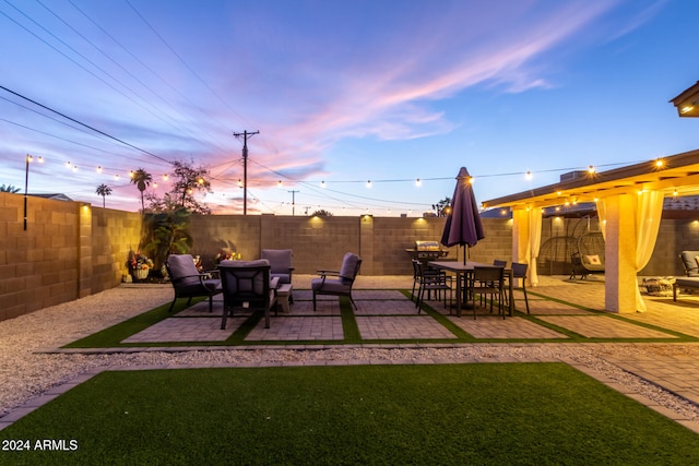 view of patio terrace at dusk