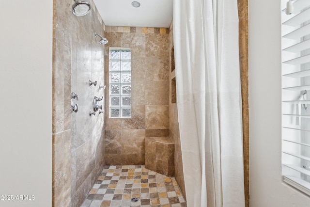 bathroom with a tile shower