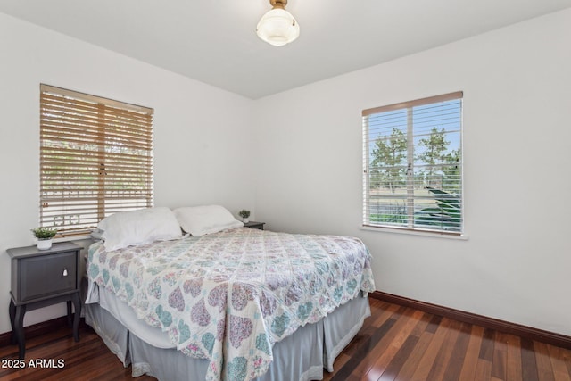 bedroom with baseboards and wood finished floors