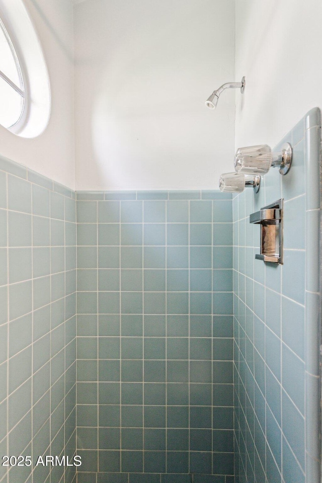 full bath featuring a tile shower