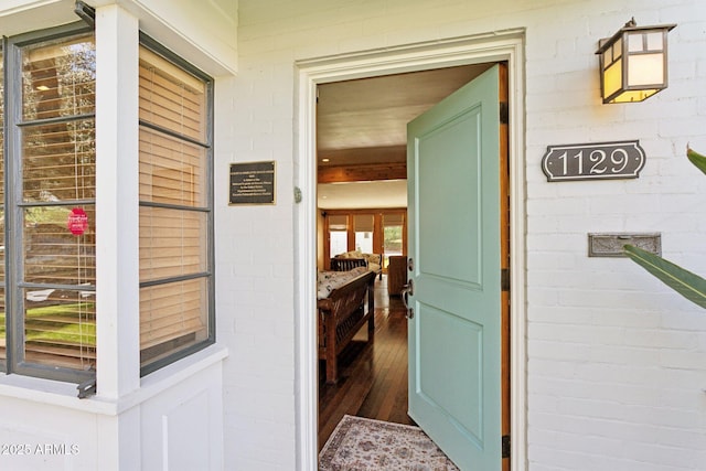 doorway to property with brick siding