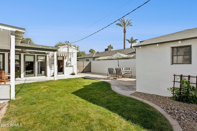 view of yard featuring fence and a patio