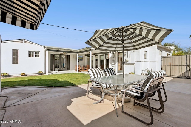 view of patio featuring fence, french doors, and outdoor dining space