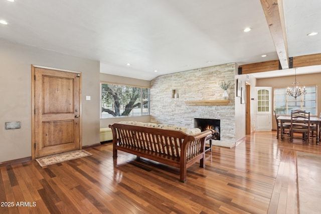 bedroom with hardwood / wood-style flooring, recessed lighting, a fireplace, baseboards, and an inviting chandelier