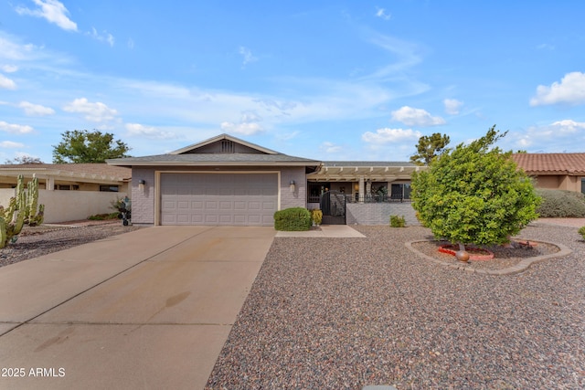 ranch-style house with an attached garage, fence, concrete driveway, and brick siding