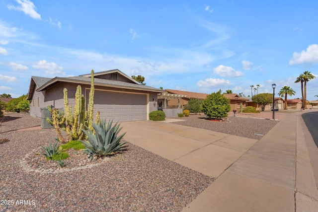 view of front facade featuring a garage, concrete driveway, and stucco siding