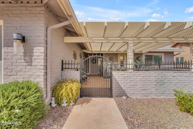 exterior space featuring a gate, brick siding, fence, and a pergola