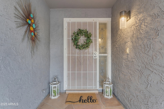 property entrance with stucco siding