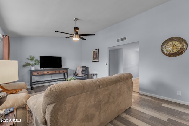 living room with a ceiling fan, visible vents, baseboards, and wood finished floors