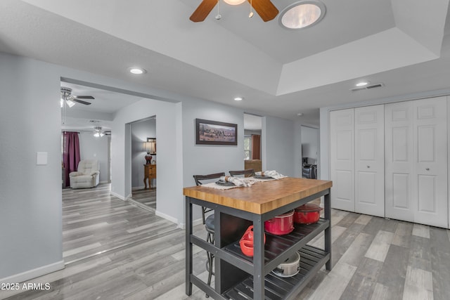 interior space with light wood finished floors, visible vents, baseboards, and recessed lighting