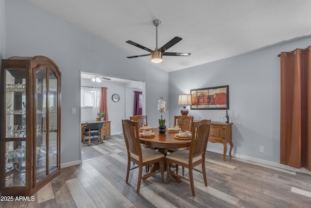 dining space with ceiling fan, baseboards, and wood finished floors