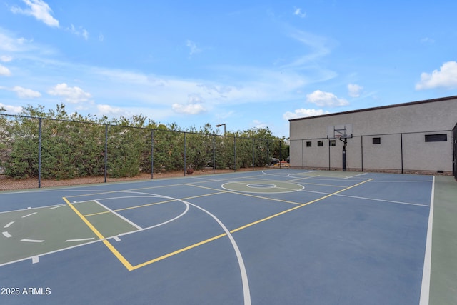 view of basketball court featuring community basketball court and fence