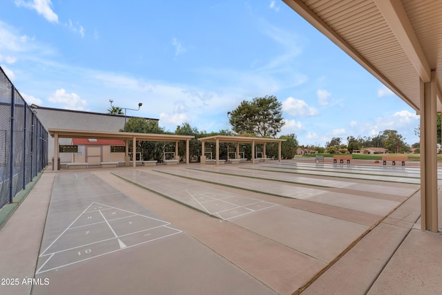 view of home's community featuring fence and shuffleboard