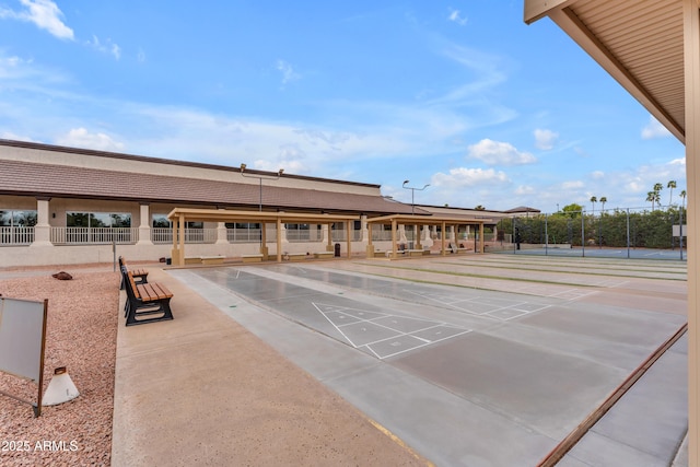 surrounding community featuring fence and shuffleboard