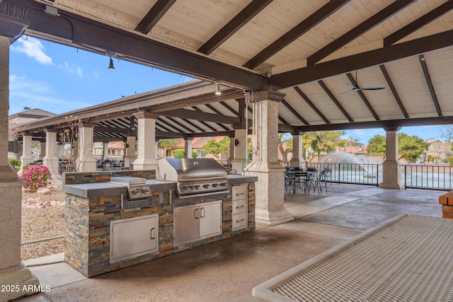 view of patio / terrace featuring area for grilling, a gazebo, outdoor dining space, and an outdoor kitchen