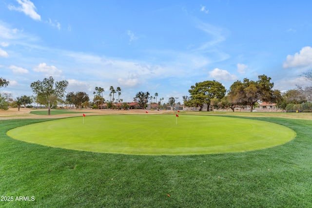 view of property's community with a lawn and golf course view