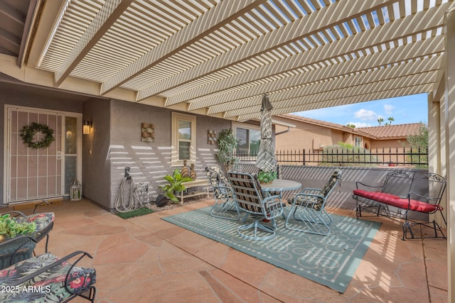 view of patio / terrace featuring fence and a pergola