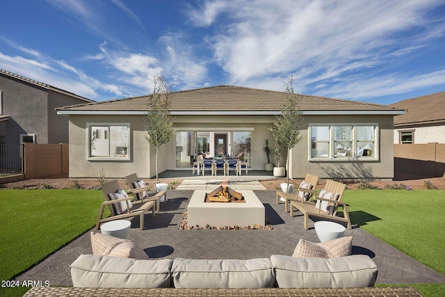 back of house with a patio, a yard, and a fire pit