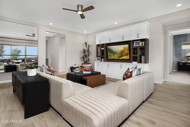 living room with light hardwood / wood-style floors and ceiling fan