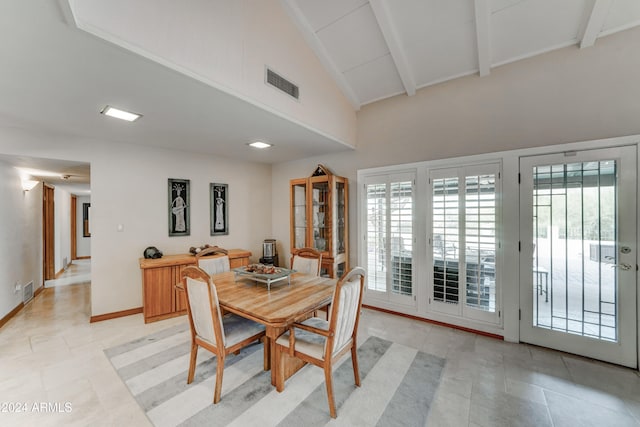 dining space with beamed ceiling, light tile patterned floors, and high vaulted ceiling