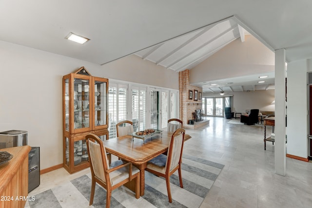 dining area featuring vaulted ceiling with beams