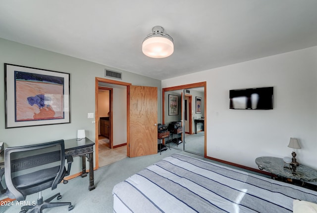 bedroom featuring light colored carpet and a closet