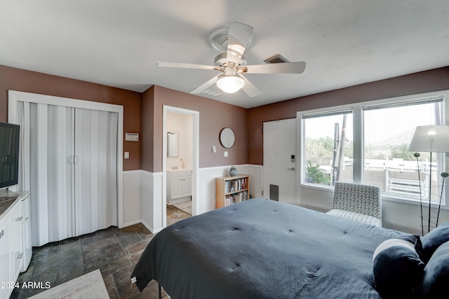 bedroom with ceiling fan and ensuite bath