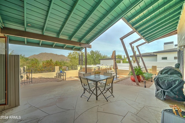 view of patio with a mountain view and grilling area