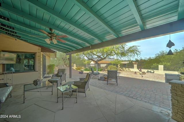 view of patio / terrace featuring an outdoor living space with a fireplace and ceiling fan