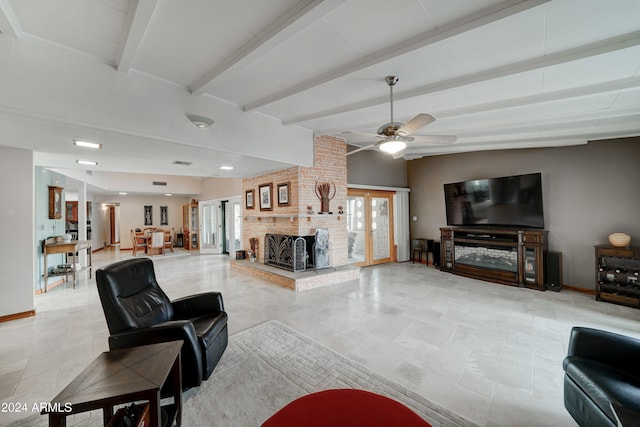 living room with vaulted ceiling with beams, ceiling fan, and a fireplace