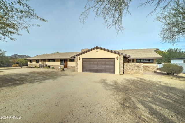 single story home with a mountain view and a garage