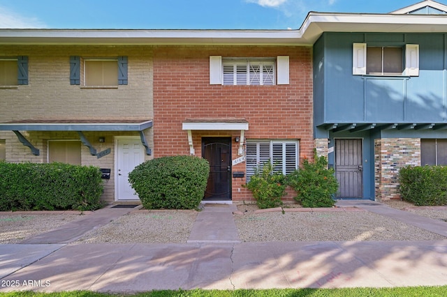 townhome / multi-family property with brick siding