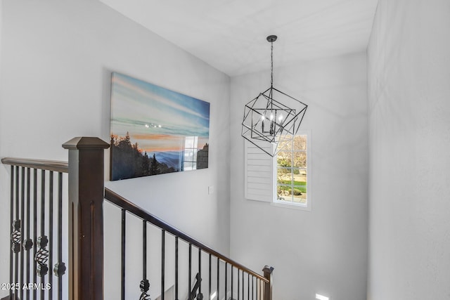 stairs featuring a chandelier