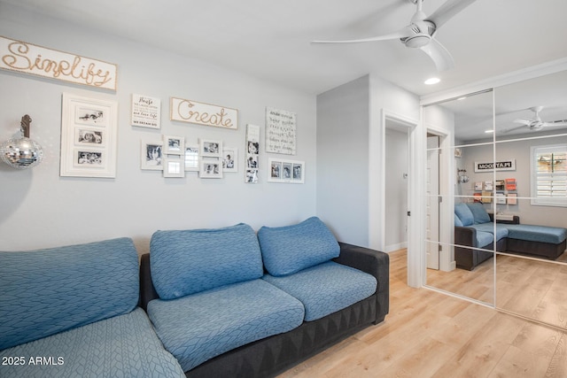 living room with light wood-style floors and ceiling fan