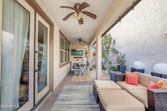 view of patio with an outdoor living space and a ceiling fan