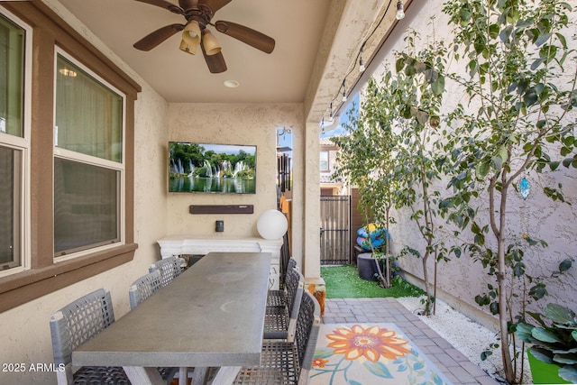 view of patio / terrace featuring fence and ceiling fan