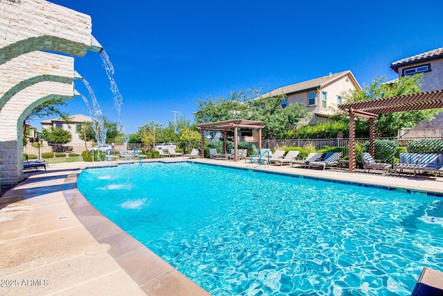 community pool with a patio area, fence, and a pergola