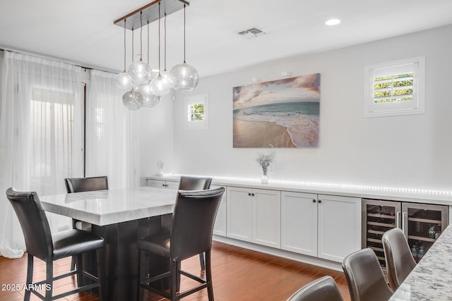 dining room with dark wood-style floors, visible vents, and recessed lighting