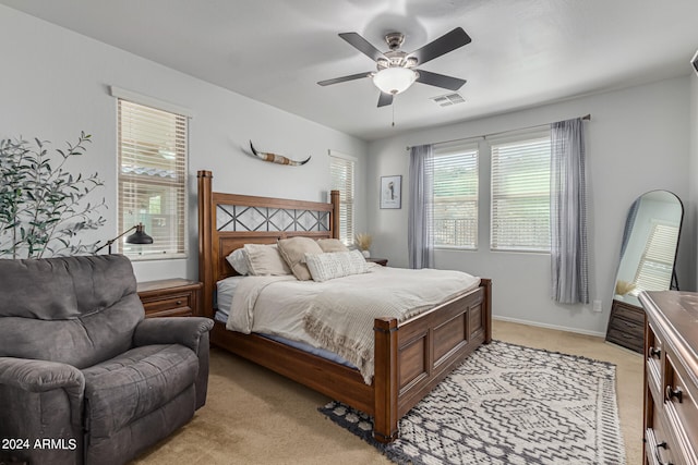 bedroom with ceiling fan and light colored carpet