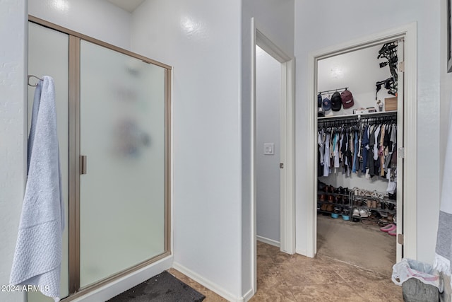 bathroom featuring tile patterned floors and a shower with shower door