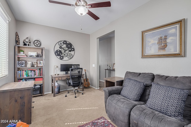 carpeted office featuring ceiling fan