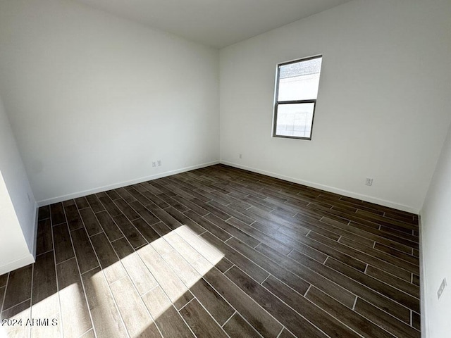 unfurnished room with dark hardwood / wood-style flooring