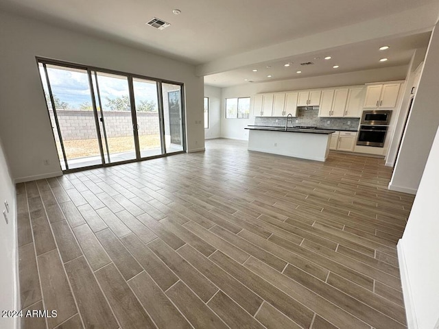 unfurnished living room featuring hardwood / wood-style flooring