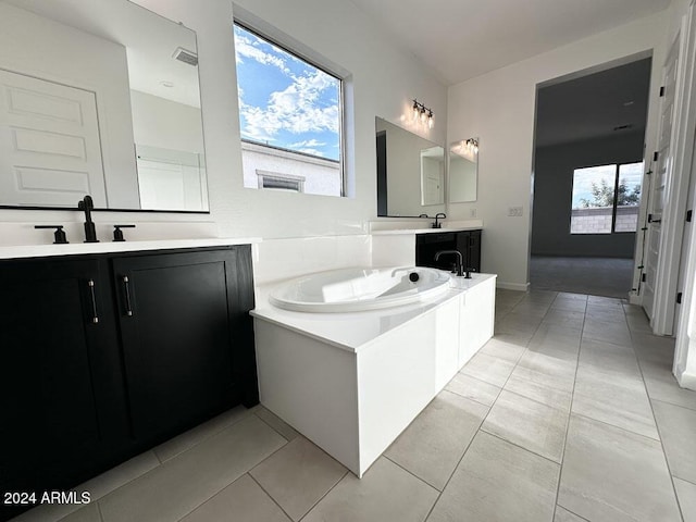 bathroom with tile patterned flooring, vanity, and a tub to relax in