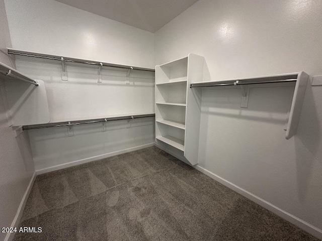 spacious closet featuring dark carpet