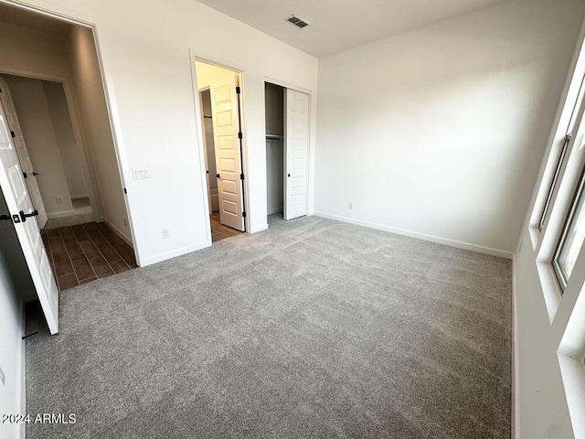 unfurnished bedroom featuring a closet and carpet